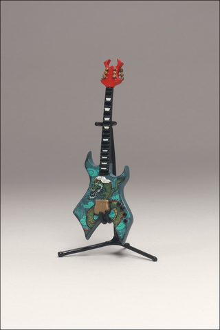 Illustration for article titled McFarlane's Tiny, Plastic Guitar Hero Guitars